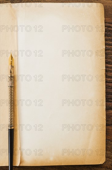 Old brown paper with fountain pen, studio shot.