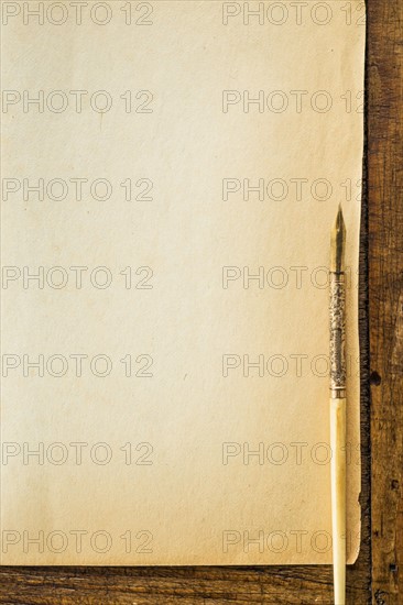 Old brown paper with fountain pen, studio shot.