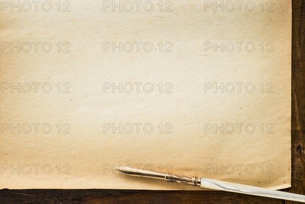 Old brown paper with fountain pen, studio shot.