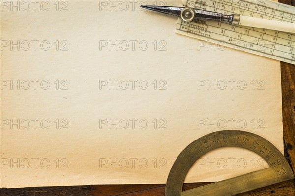 Old brown paper with protractor, studio shot.