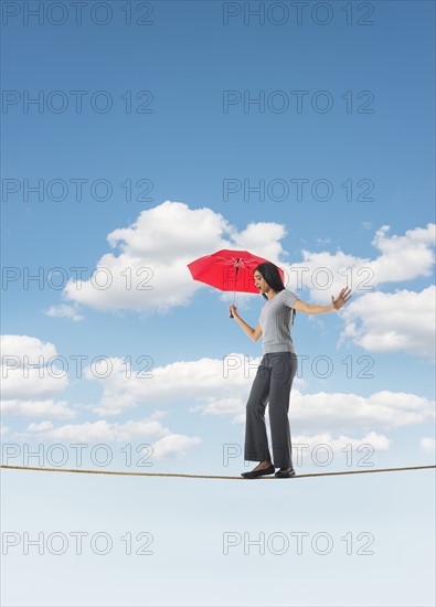 Woman balancing on tightrope.