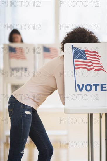 Woman in voting booth.