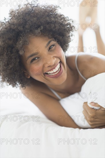 Portrait of woman lying on bed.