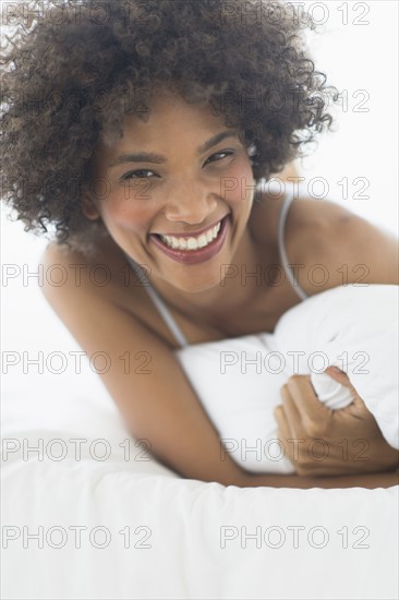 Portrait of woman lying on bed.