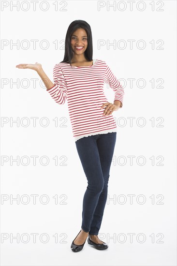 Portrait of woman gesturing, studio shot.