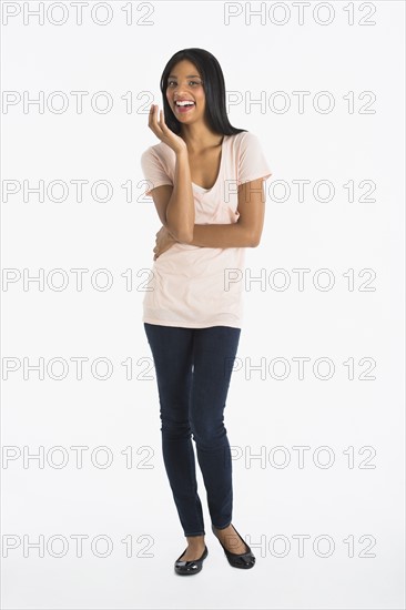 Portrait of woman smiling, studio shot.