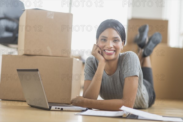 Businesswoman using laptop in new office.