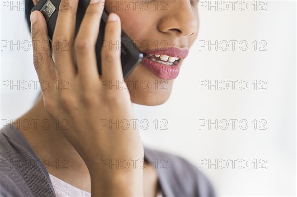 Businesswoman talking on phone, studio shot.