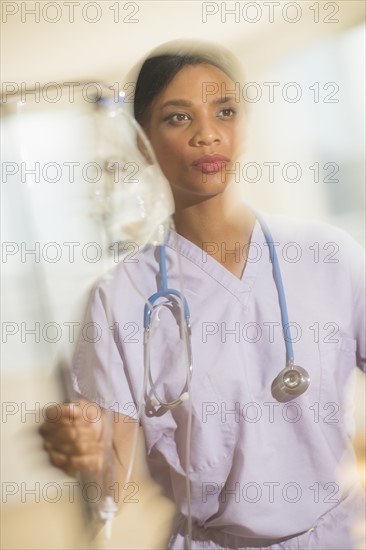 Female doctor rushing with iv drip.