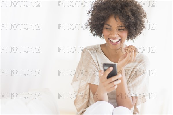 Woman using cell phone, studio shot.