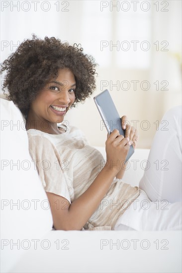 Portrait of woman holding digital tablet.