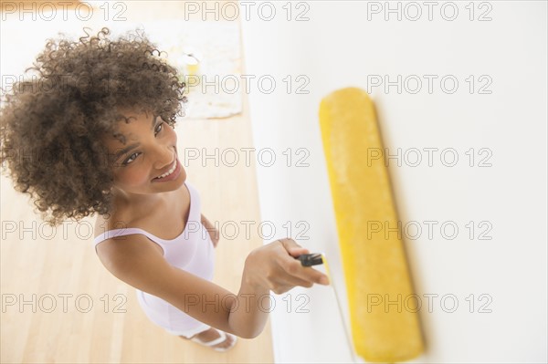 Woman painting house.