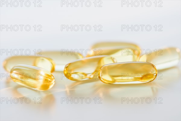 Omega fatty acid pills on white background, studio shot.