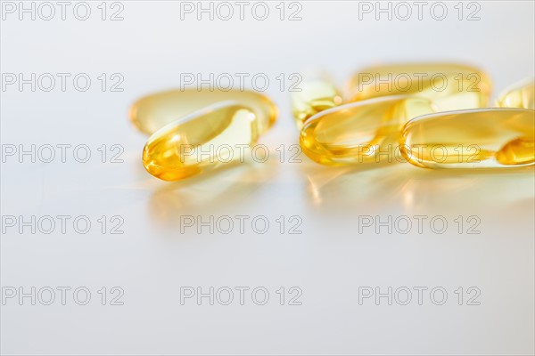 Omega fatty acid pills on white background, studio shot.