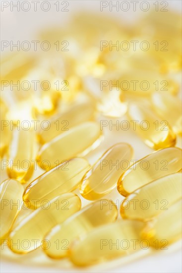 Omega fatty acid pills on white background, studio shot.