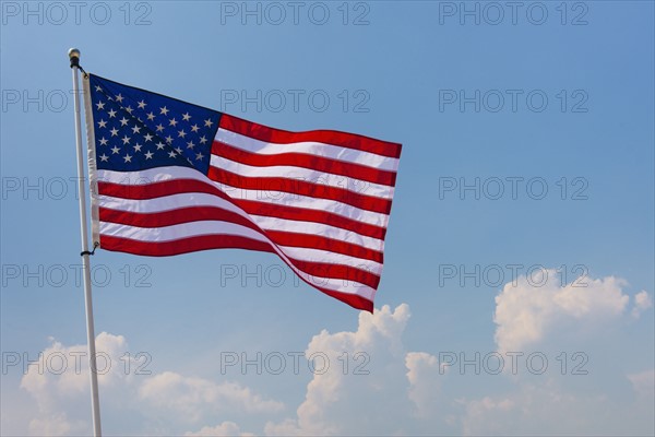 US flag against blue sky.