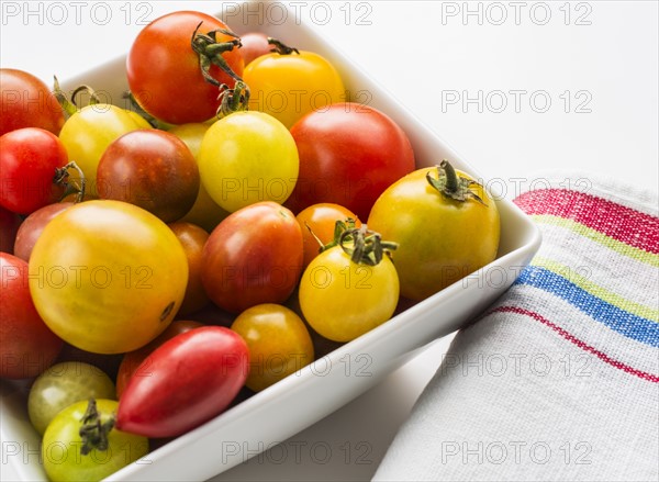 Heirloom tomatoes in plate, studio shot.