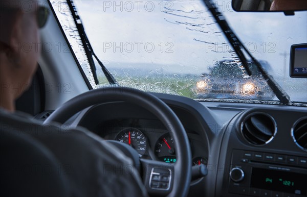 Man driving in rain.