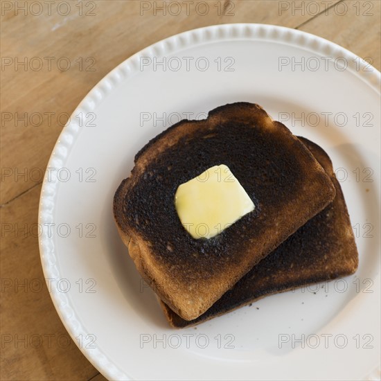 Burnt toasts on plate.