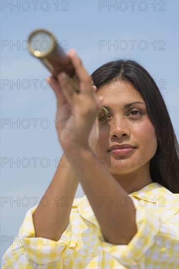 Woman looking through telescope.