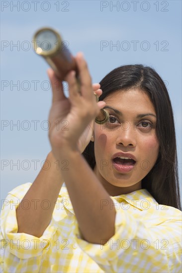 Woman looking through telescope.