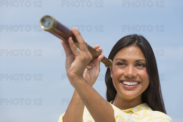 Woman looking through telescope.