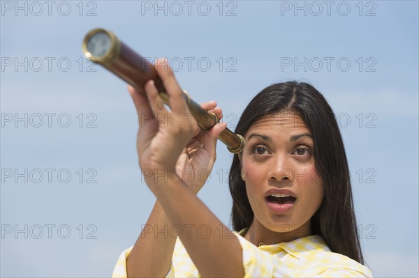 Woman looking through telescope.