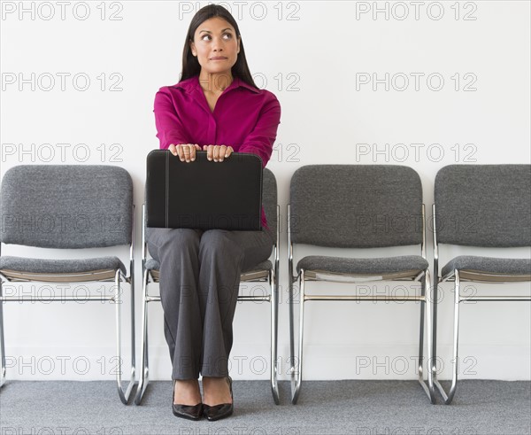 Woman sitting in waiting room.