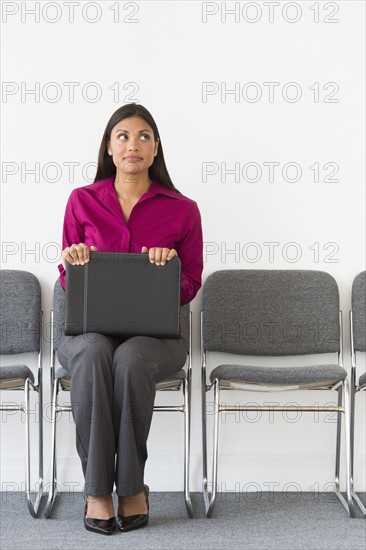 Woman sitting in waiting room.