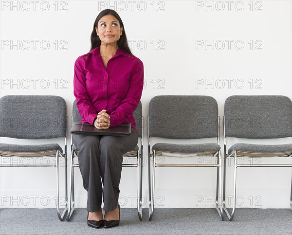 Woman sitting in waiting room.