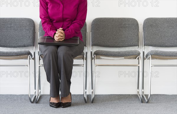 Woman sitting in waiting room.