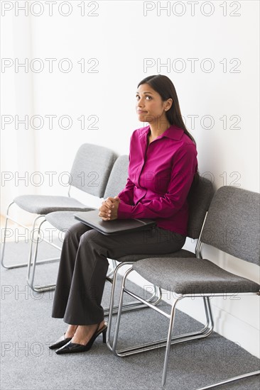 Woman sitting in waiting room.