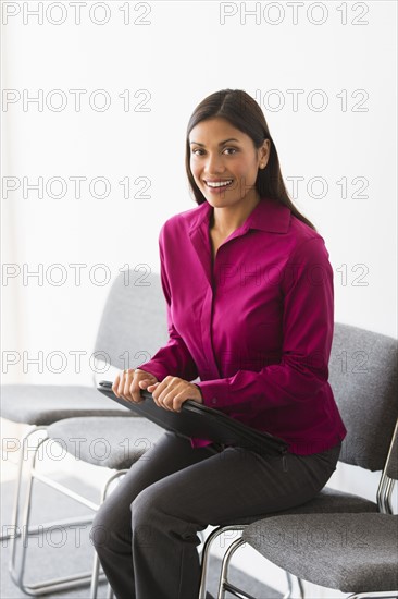 Woman sitting in waiting room.