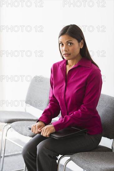 Woman sitting in waiting room.