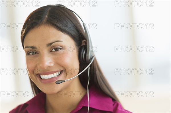 Portrait of woman wearing headset.