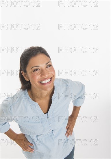 Studio shot of young woman smiling.