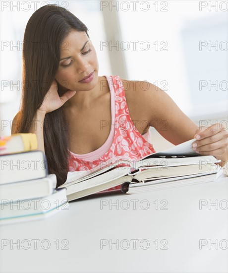 Female student reading book.