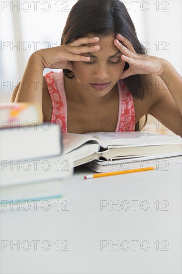 Female student reading book.