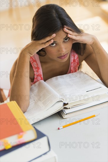 Female student reading book.