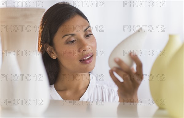 Woman choosing vase.