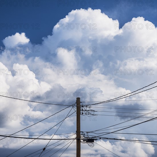 Power lines against cloudy sky.