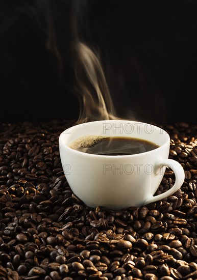 Hot coffee and coffee beans, studio shot.