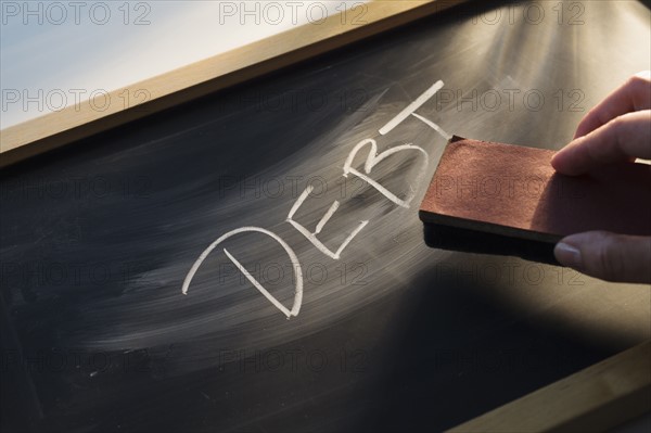 Close up of woman's hand over chalk board.