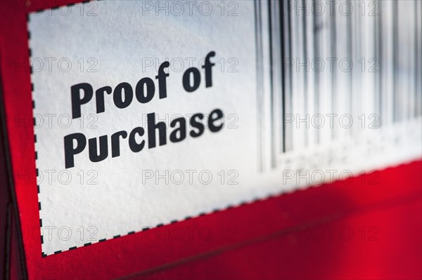 Close up of proof of purchase with bar code, studio shot.