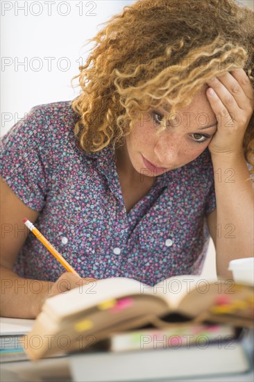 Young woman studying in library.
