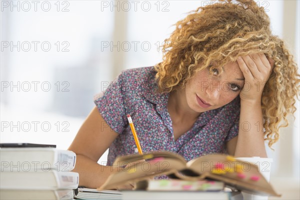 Young woman studying in library.