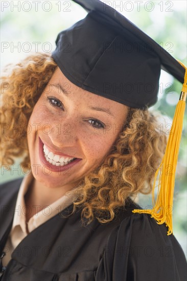 Portrait of smiling young woman in mortarboard.