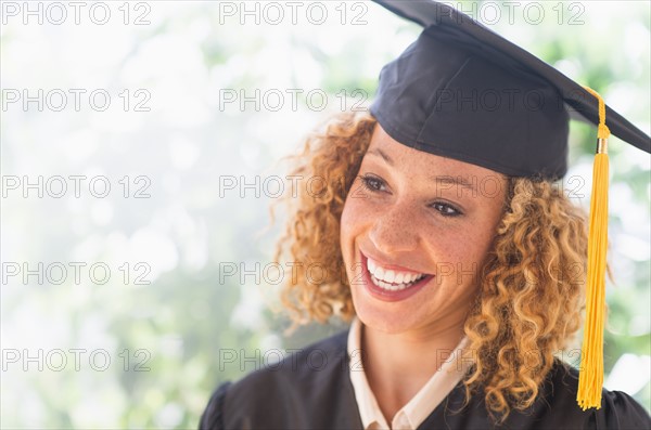 Portrait of smiling young woman in mortarboard.