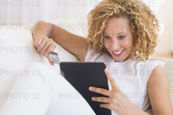 Young woman e-shopping with digital tablet.