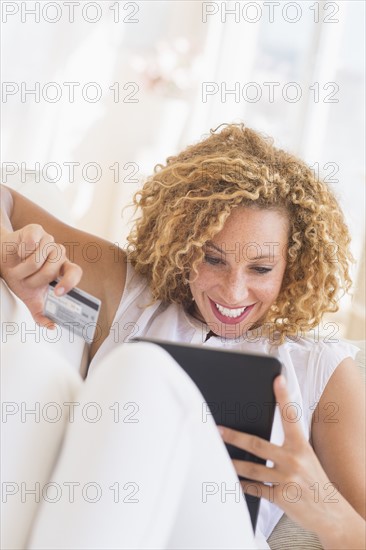 Young woman e-shopping with digital tablet.